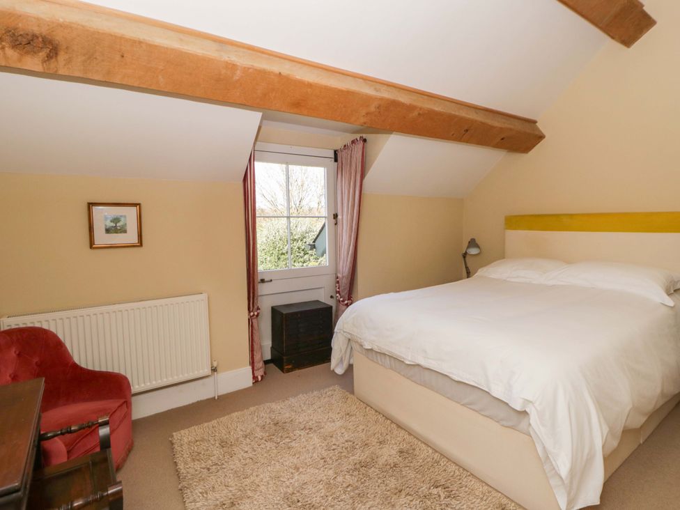 A bedroom with a bed and a desk at North Cottage in Myddfai near Llandovery