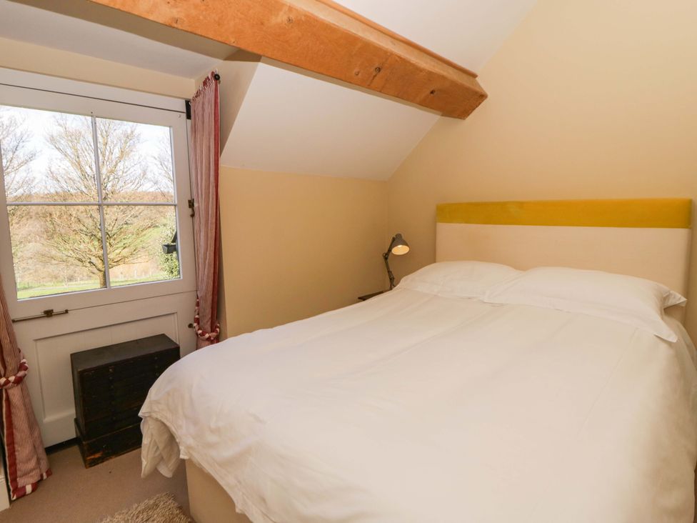 A bedroom with a bed and a window at North Cottage in Myddfai near Llandovery