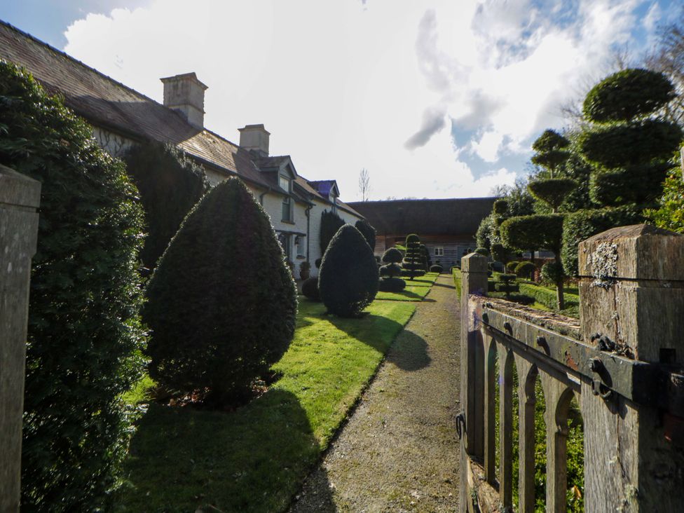 A garden with neatly trimmed hedges at North Cottage in Myddfai near Llandovery