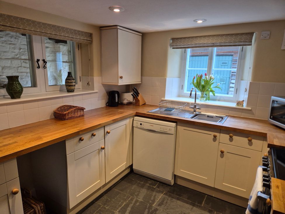 A kitchen with a sink and dishwasher at North Cottage Myddfai near Llandovery