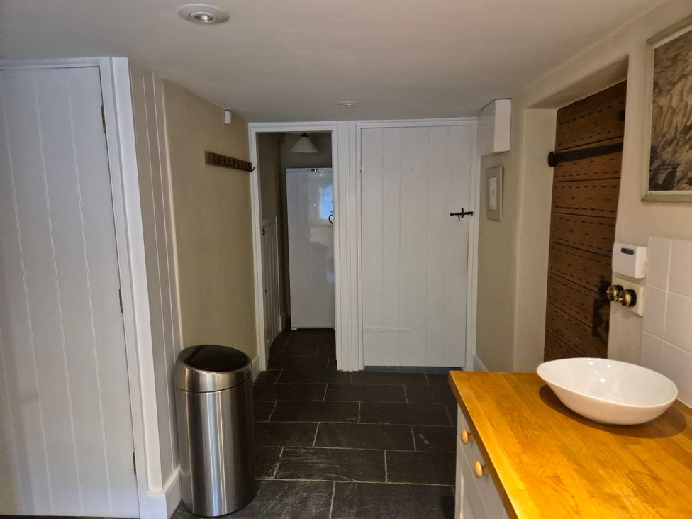 A kitchen with a counter and a fridge at North Cottage Myddfai near Llandovery