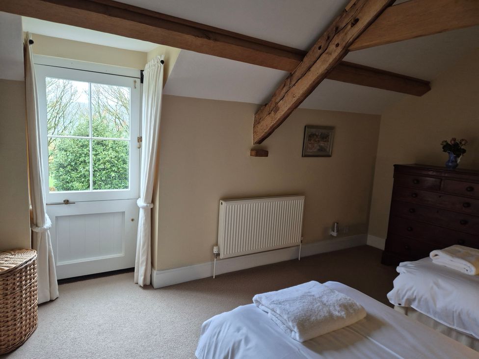 A bedroom with a window and a dresser at North Cottage in Myddfai near Llandovery