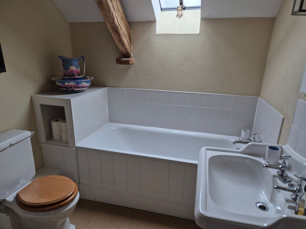 A bathroom with a bathtub, toilet, and sink at North Cottage Myddfai near Llandovery