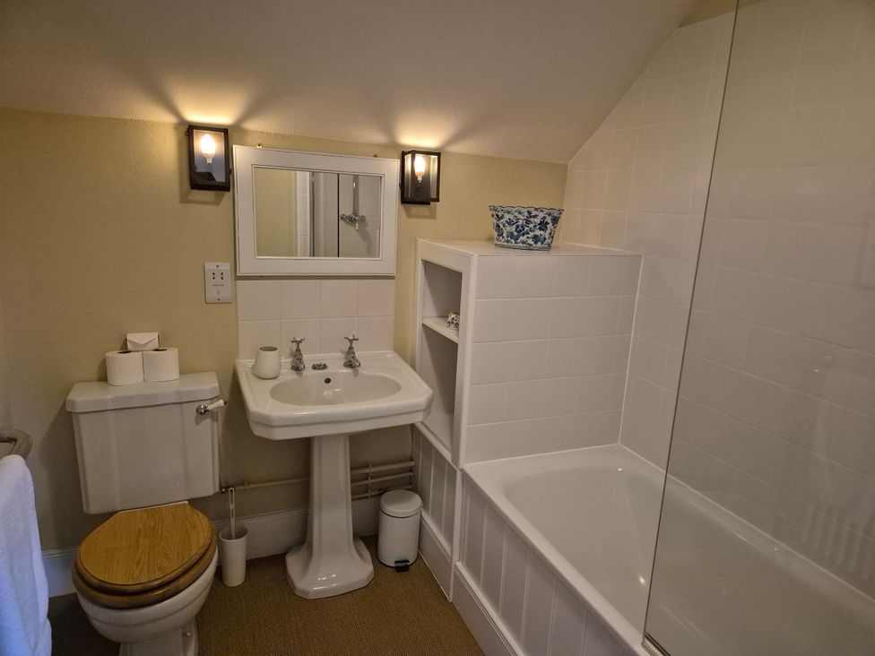 A bathroom with a sink, toilet, and bathtub at North Cottage Myddfai near Llandovery