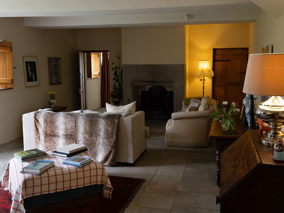 A living room with a sofa, armchair, and coffee table at North Cottage Myddfai near Llandovery