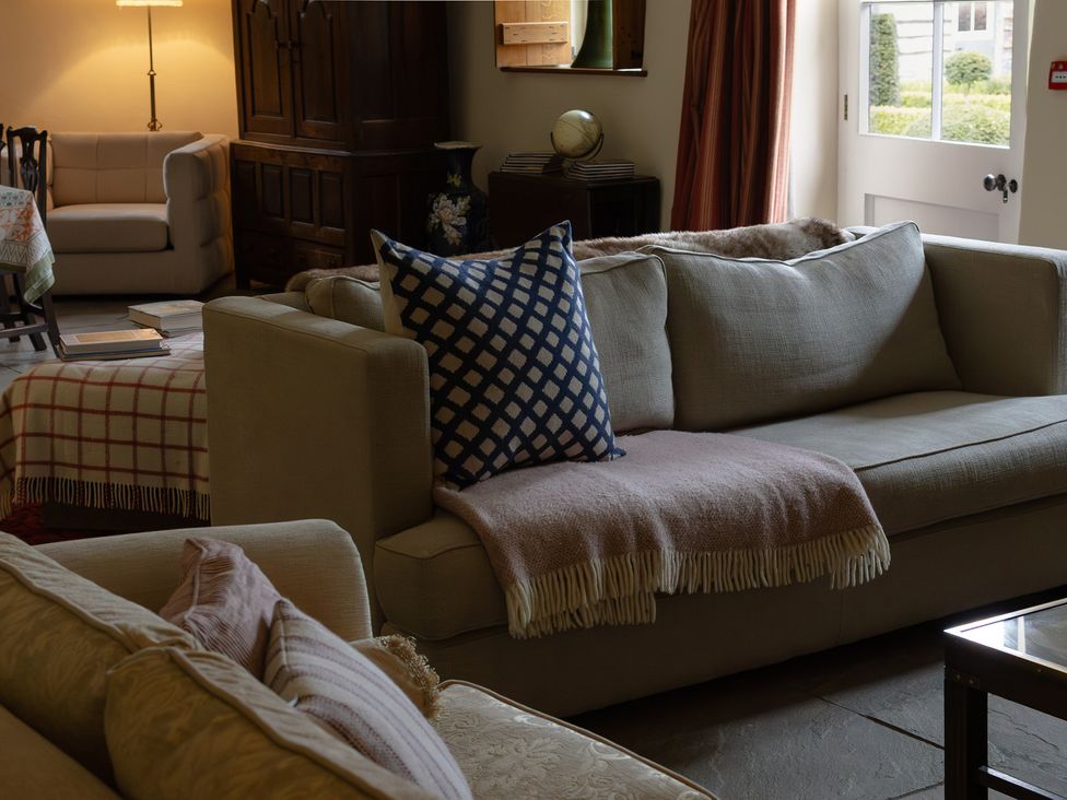 A living room with sofas and a lamp at North Cottage Myddfai near Llandovery