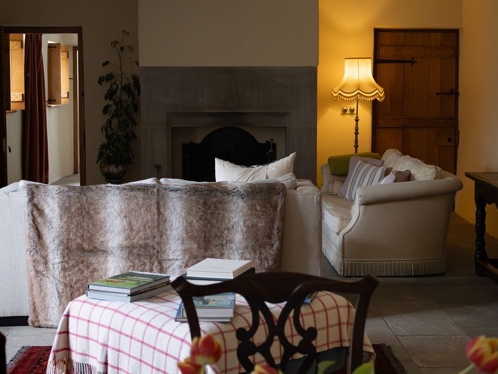 A living room with a sofa and lamp at North Cottage in Myddfai near Llandovery
