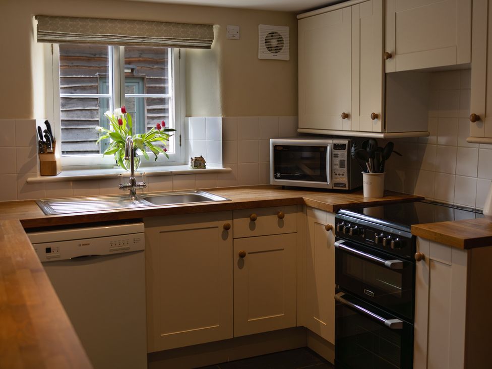 A kitchen with a sink and appliances at North Cottage in Myddfai near Llandovery