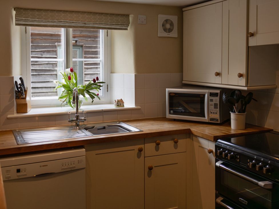 A kitchen with a sink and dishwasher at North Cottage in Myddfai near Llandovery