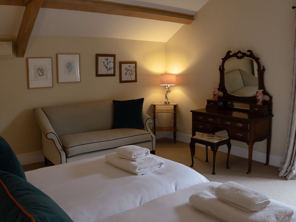 A bedroom with a sofa and dressing table at North Cottage Myddfai near Llandovery