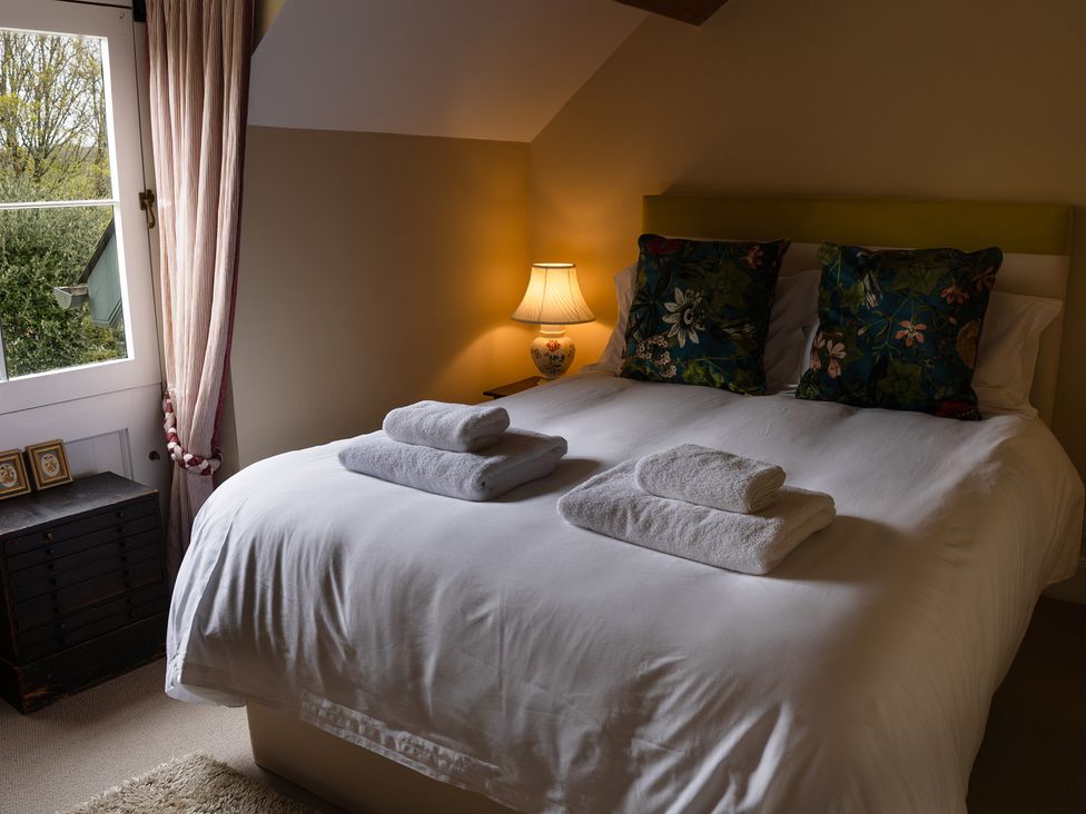 A bedroom with a bed and nightstand at North Cottage Myddfai near Llandovery