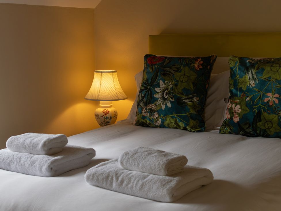 A bedroom with a bed and lamps at North Cottage Myddfai near Llandovery