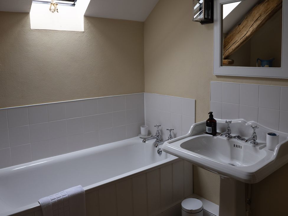 A bathroom with a bathtub and sink at North Cottage Myddfai near Llandovery