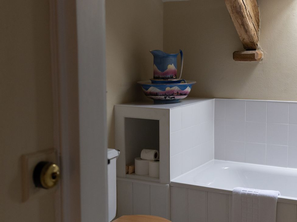 A bathroom with a bathtub and a toilet at North Cottage Myddfai near Llandovery
