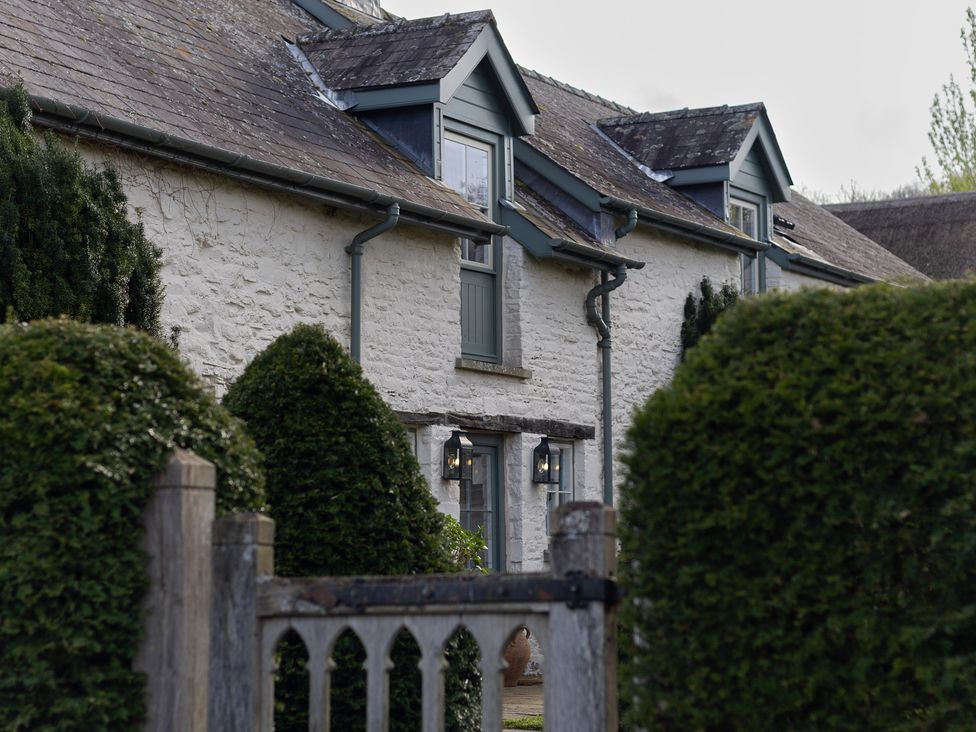 A house with windows and hedges in front at North Cottage in Myddfai near Llandovery