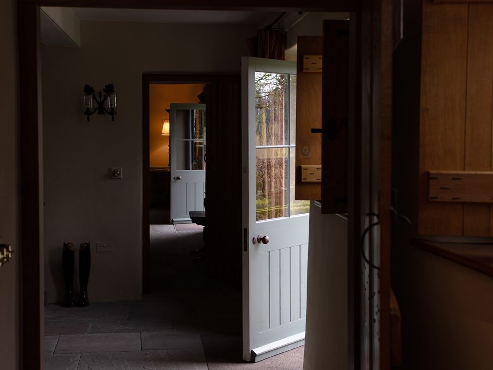 A hallway with doors and a lamp at North Cottage Myddfai near Llandovery