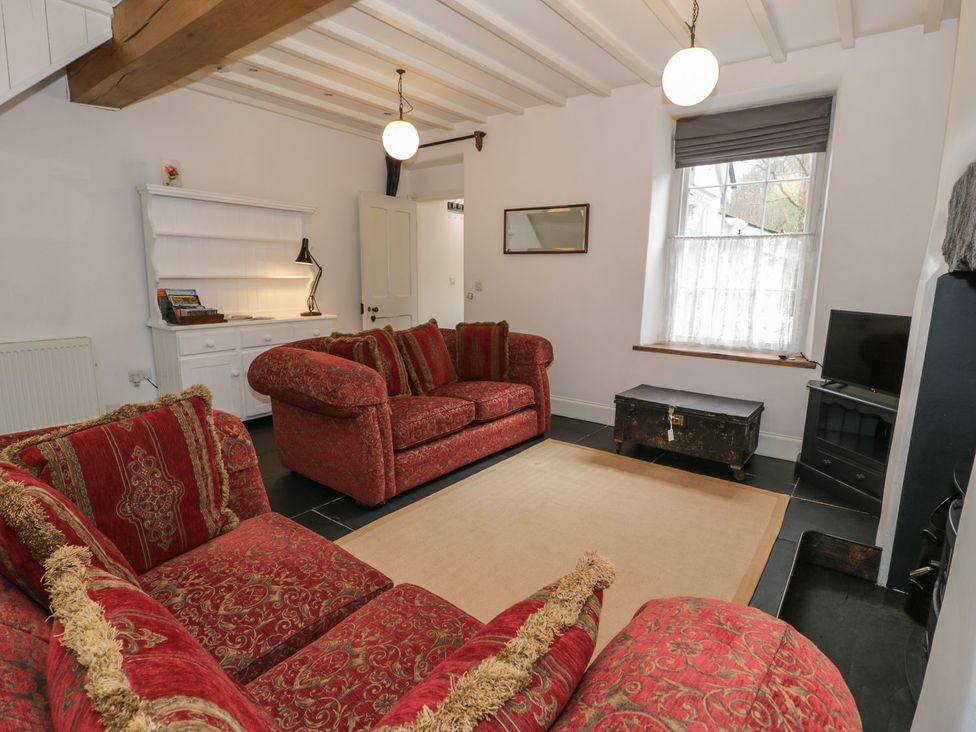 A living room with a sofa and coffee table at Peniel Cottage in Caernarfon