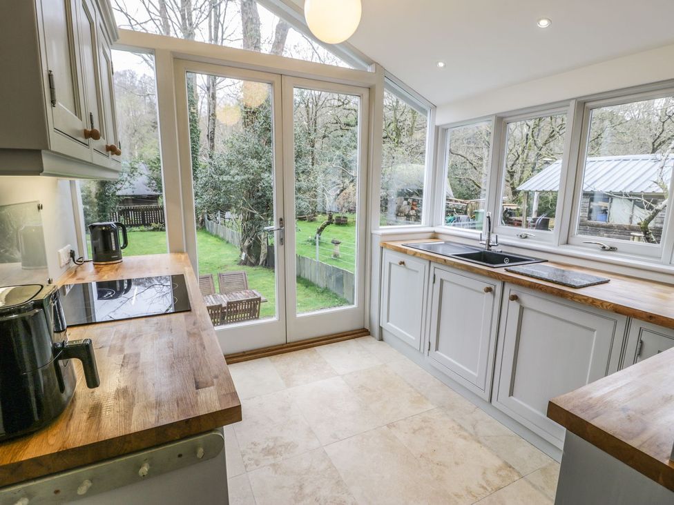 A kitchen with a sink and countertops at Peniel Cottage in Caernarfon