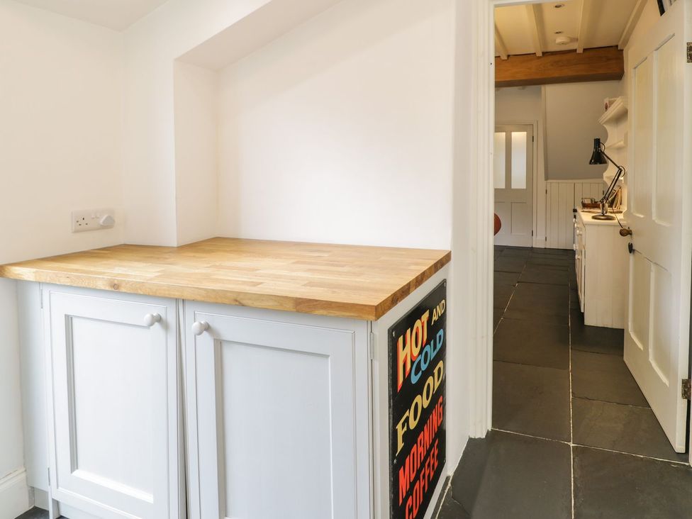 A kitchen with a wooden worktop and cabinet at Peniel Cottage Caernarfon