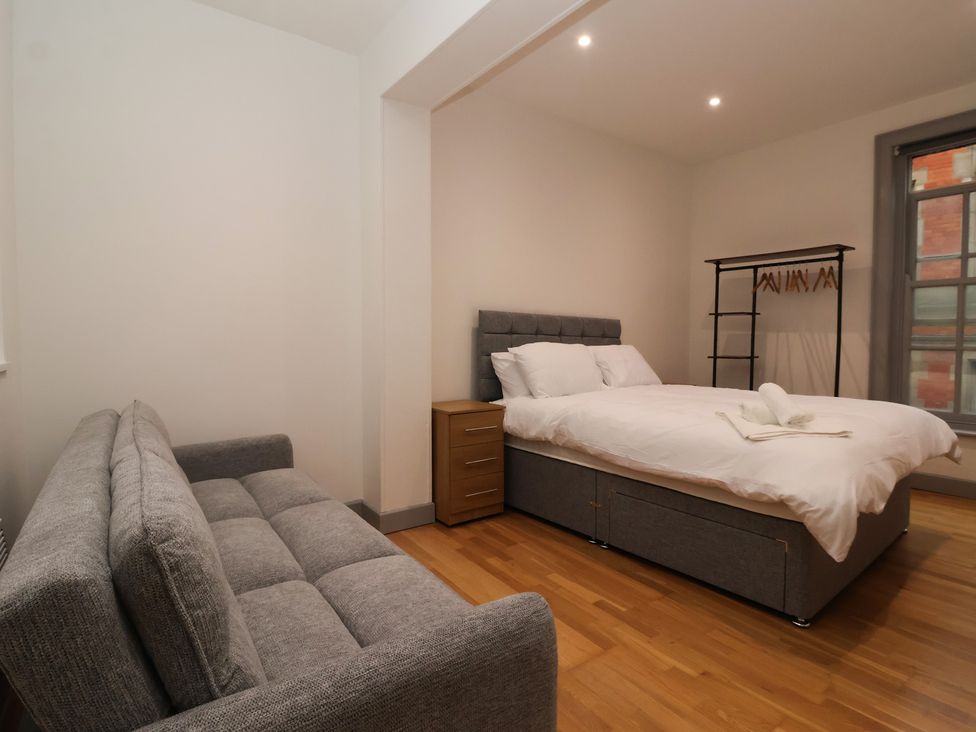 A bedroom with a bed and a sofa at Apartment 10 in York