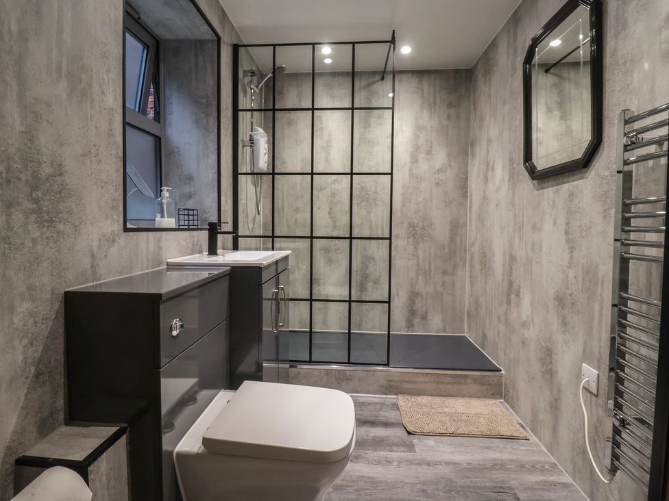 A bathroom with a shower, sink, and toilet at Apartment 10 in York
