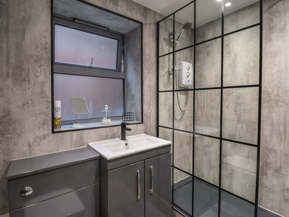 A bathroom with sink and shower at Apartment 10 in York