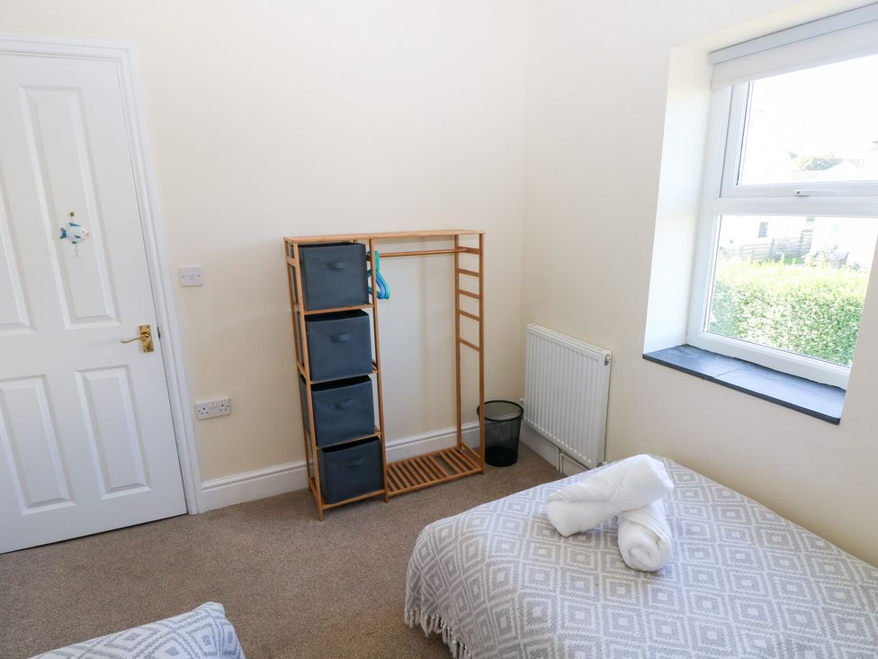 A bedroom with storage and a bed at Hawthorns in Swansea