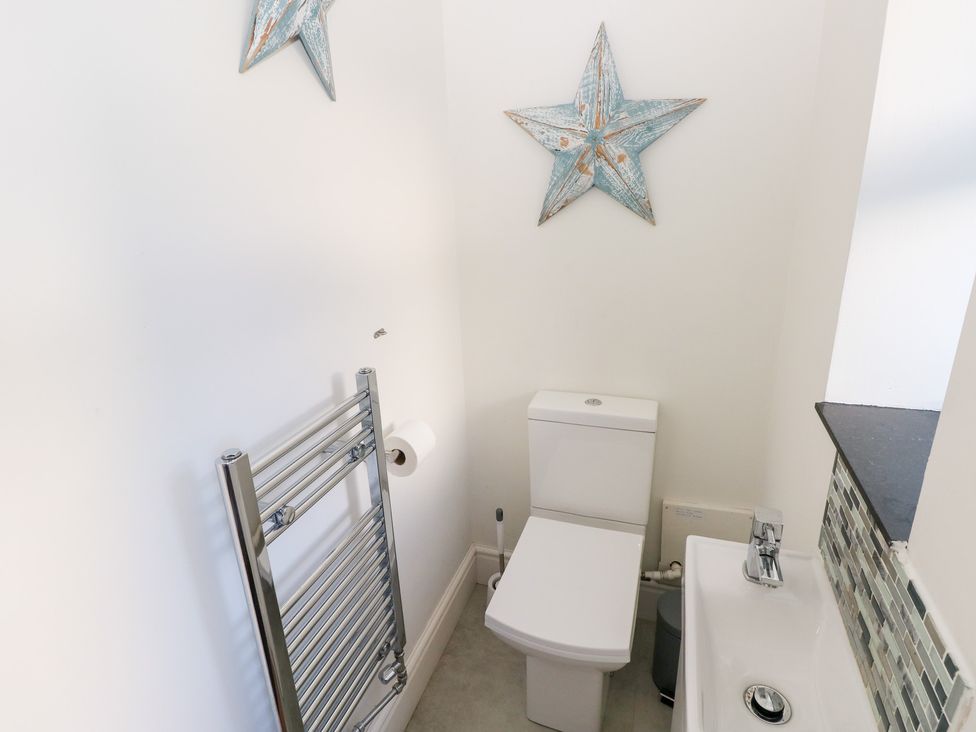 A bathroom with a toilet and sink at Hawthorns in Swansea