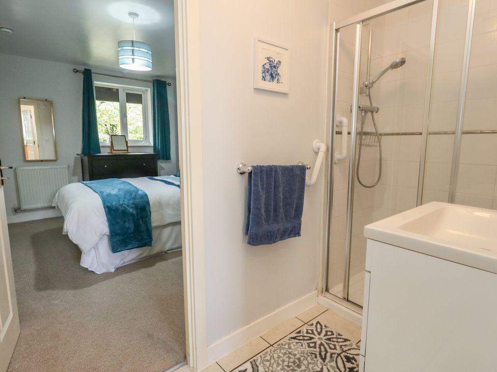 A bathroom with a shower and sink at June Cottage in Wool