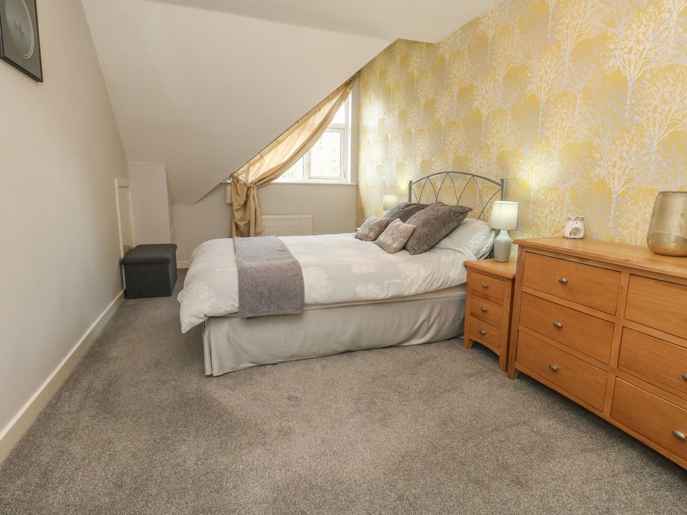 A bedroom with a bed and chest of drawers at June Cottage in Wool