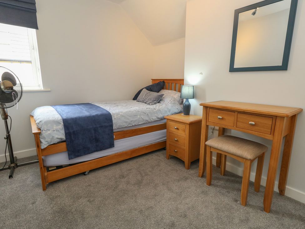 A bedroom with a bed and furniture at June Cottage in Wool