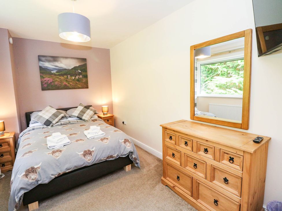 A bedroom with a bed and dresser at 1 Balnakeil in Dunbeg