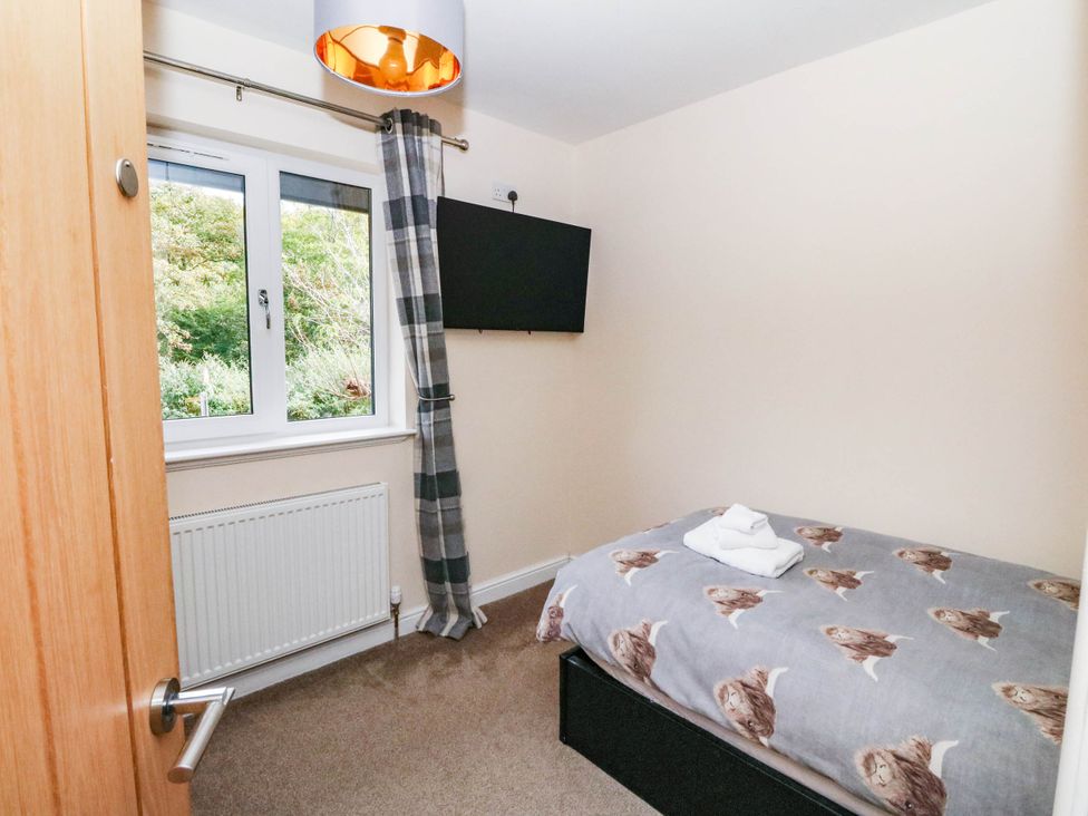 A bedroom with a bed and television at 1 Balnakeil, Dunbeg