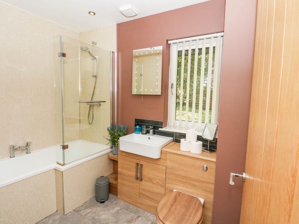 A bathroom with a shower and bathtub at 1 Balnakeil in Dunbeg