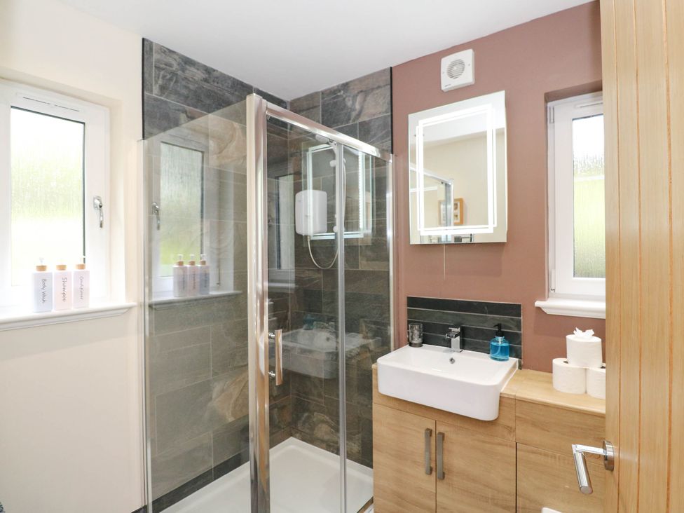 A bathroom with a shower and sink at 1 Balnakeil, Dunbeg