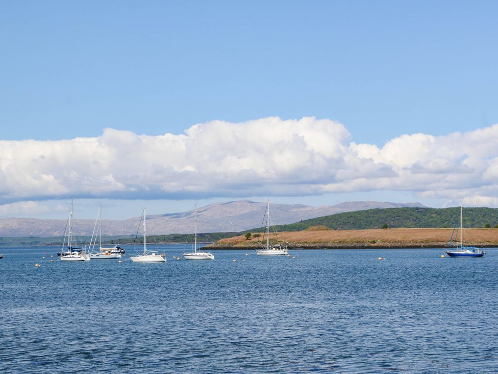 Sailboats on the water with mountains and clouds in the background at 1 Balnakeil Dunbeg