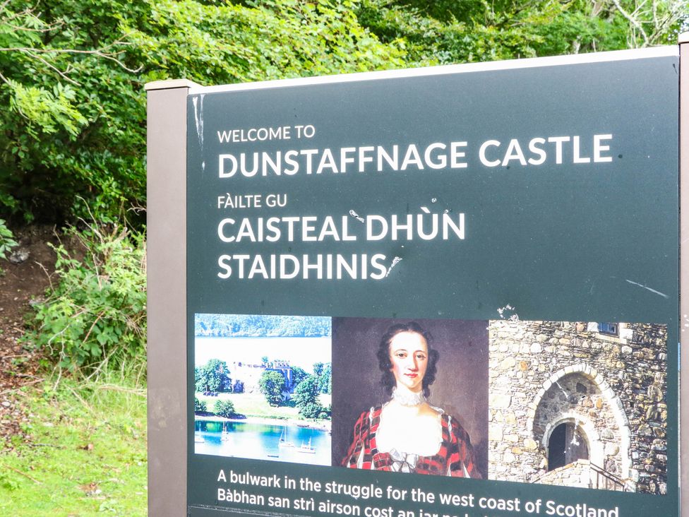 A sign welcoming visitors to Dunstaffnage Castle near Oban