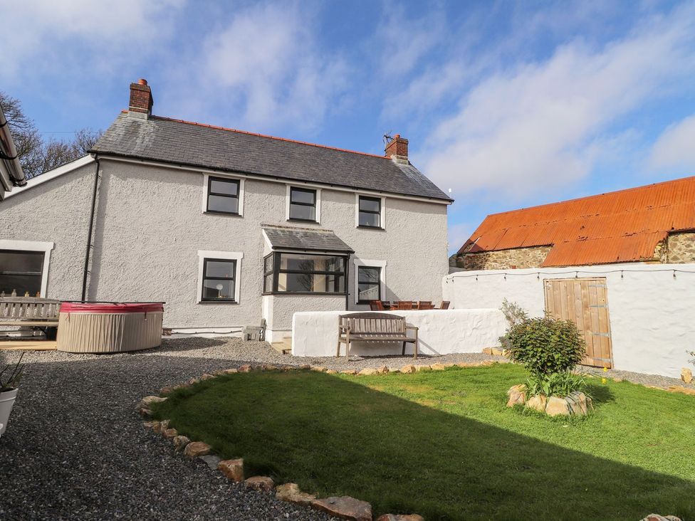 An outdoor area with a house and hot tub at Clawddcam in Mathry