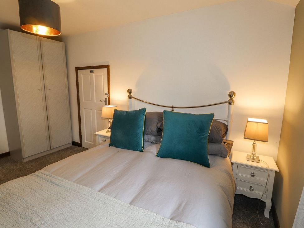 A bedroom with a bed and wardrobe at Clawddcam in Mathry