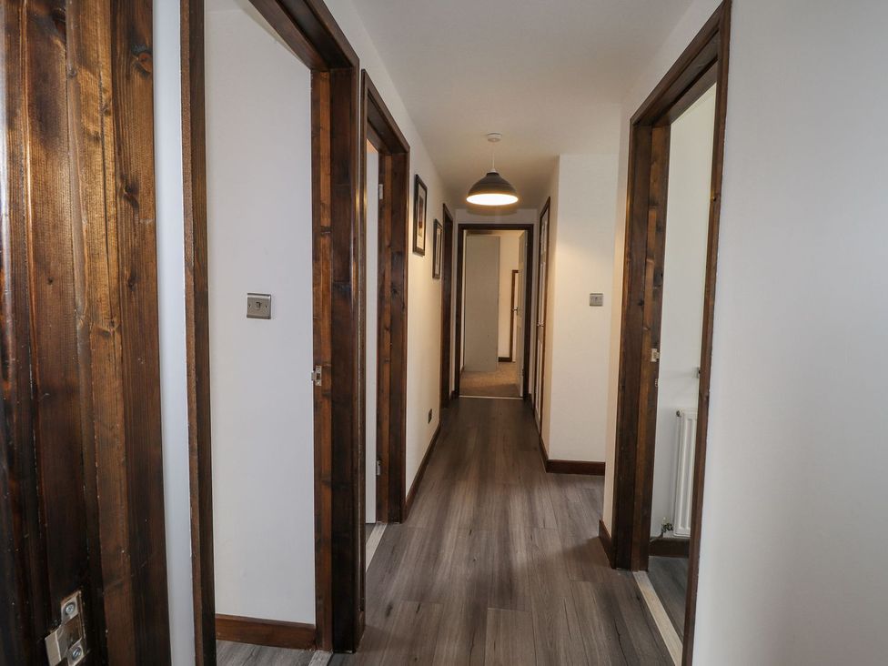 A hallway with doors on either side at Clawddcam in Mathry