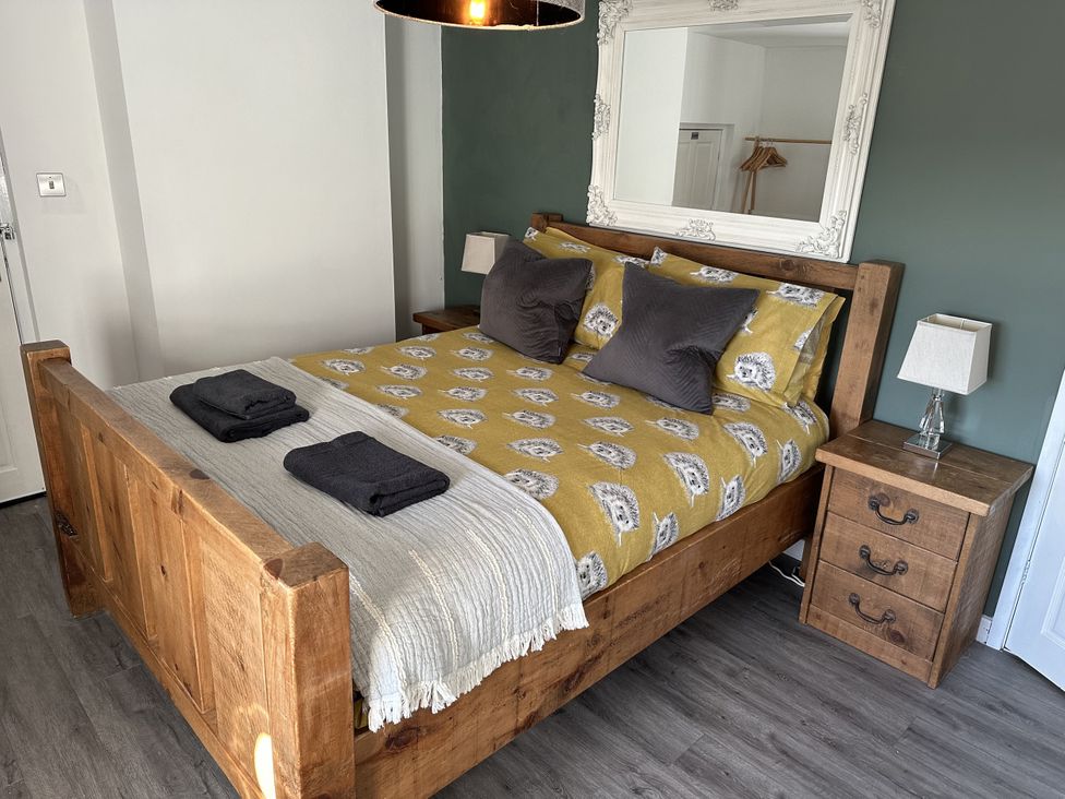 A bedroom with a bed and nightstand at Clawddcam in Mathry