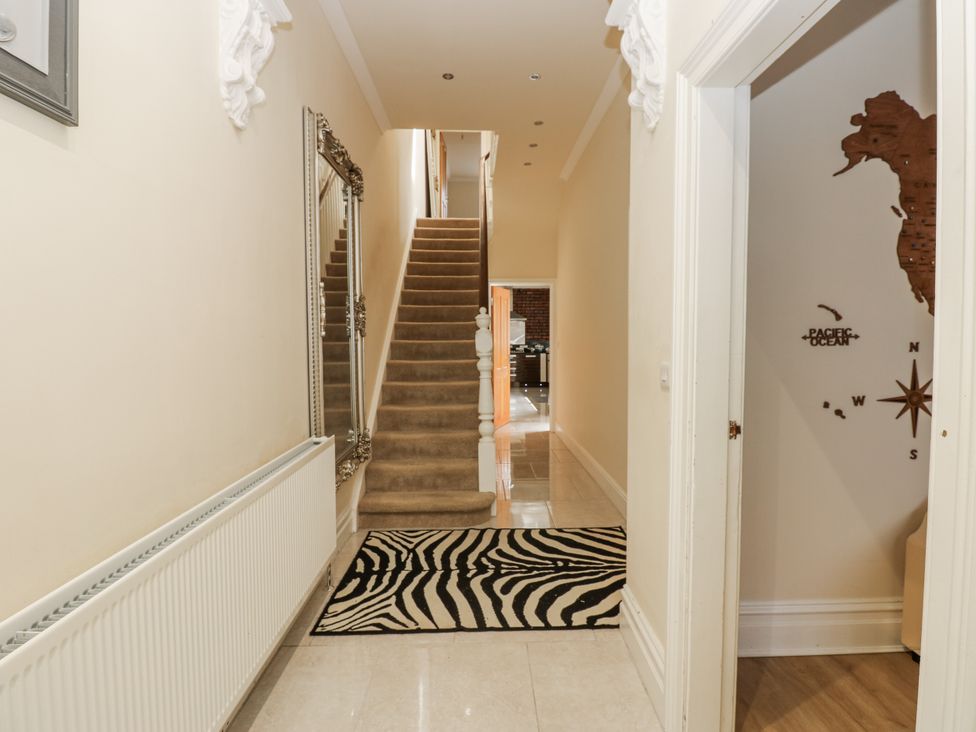 A hallway with a staircase and mirror at St Ronans in Bishop Auckland