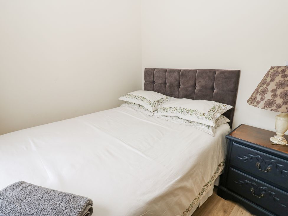 A bedroom with a bed and lamp at St Ronans in Bishop Auckland