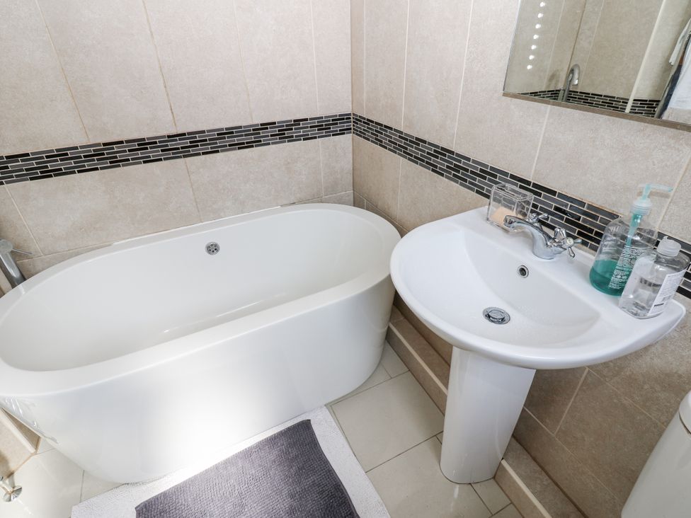 A bathroom with a bathtub and sink at St Ronans Bishop Auckland