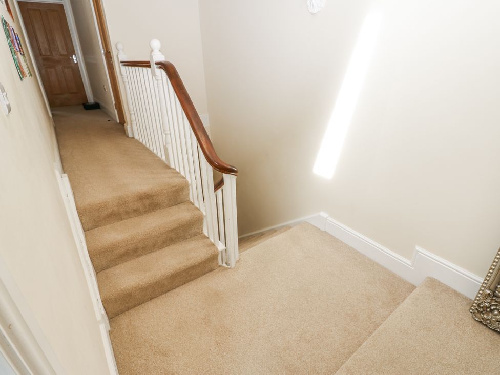 A staircase with a banister and door at St Ronans Bishop Auckland