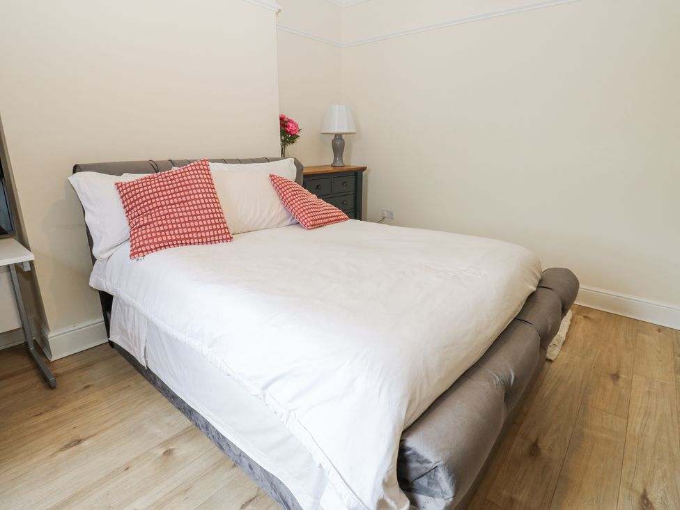 A bedroom with a bed and bedside table at St Ronans in Bishop Auckland