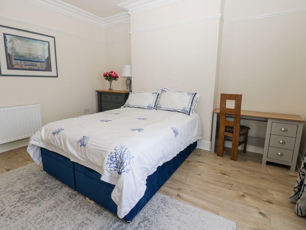 A bedroom with a bed and desk at St Ronans in Bishop Auckland