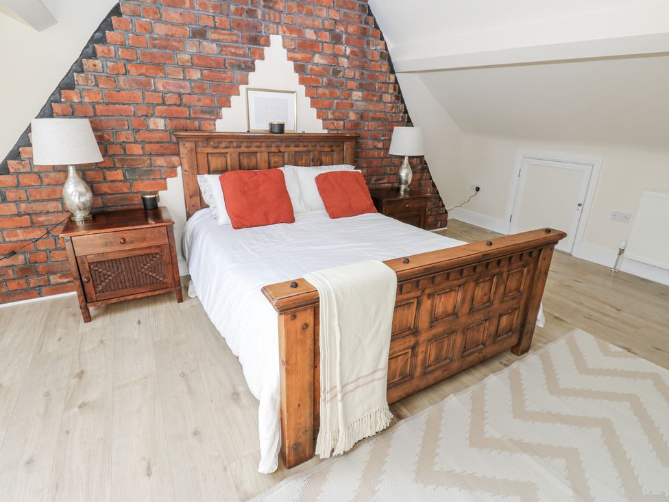 A bedroom with a bed and bedside tables at St Ronans in Bishop Auckland