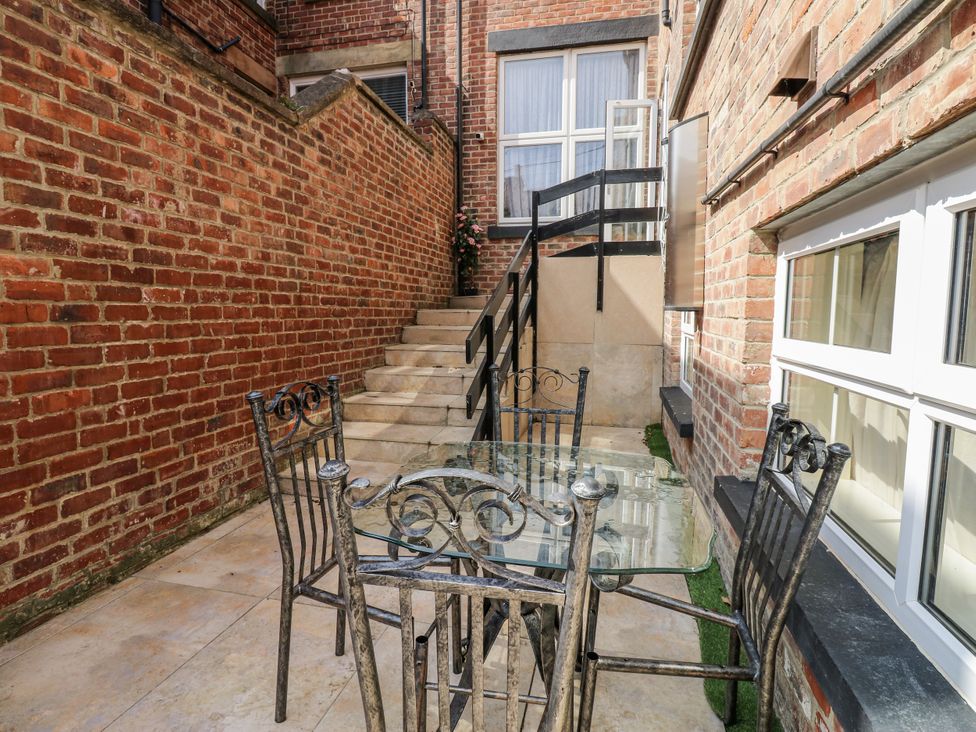 An outdoor area with a table and chairs at St Ronans in Bishop Auckland