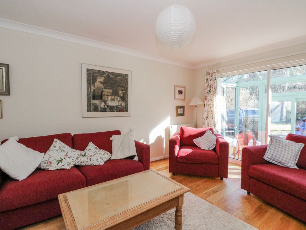 A living room with sofas and a coffee table at Grianach in Balnaguard near Strathtay